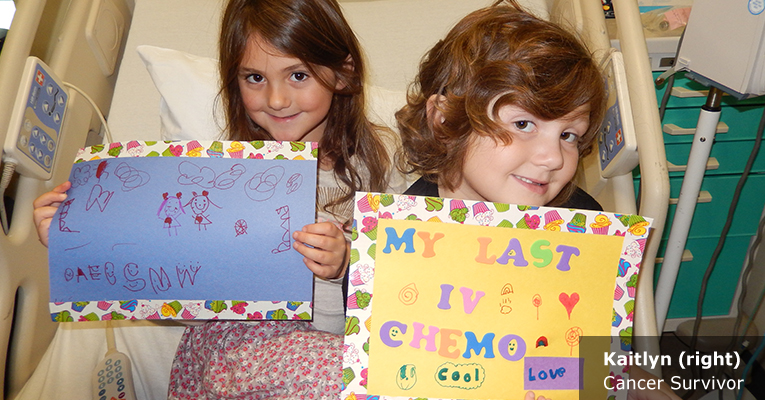 Image of young Kaitlyn, a Cancer Survivor, holding a handmade survivor sign